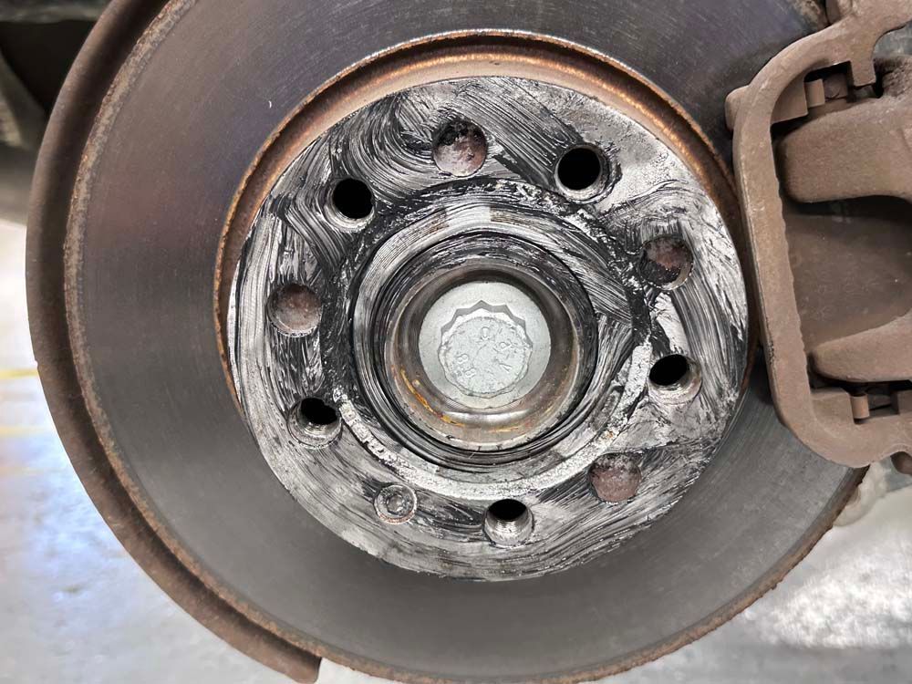 A close up of a brake disc on a car.