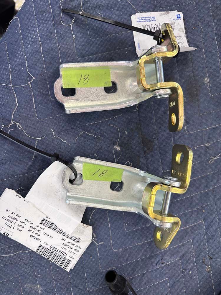 A pair of door hinges with the number 15 on them