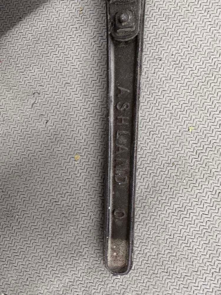 A close up of a wrench on a table.