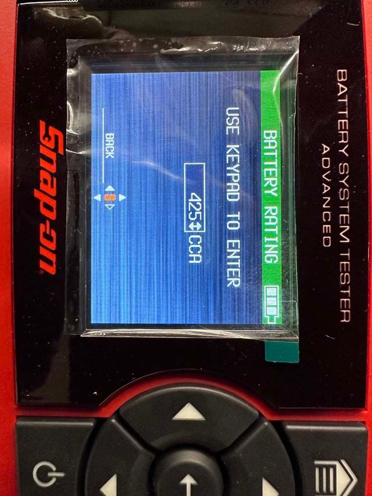 A snap-on battery system tester has a screen that says use keypad to enter