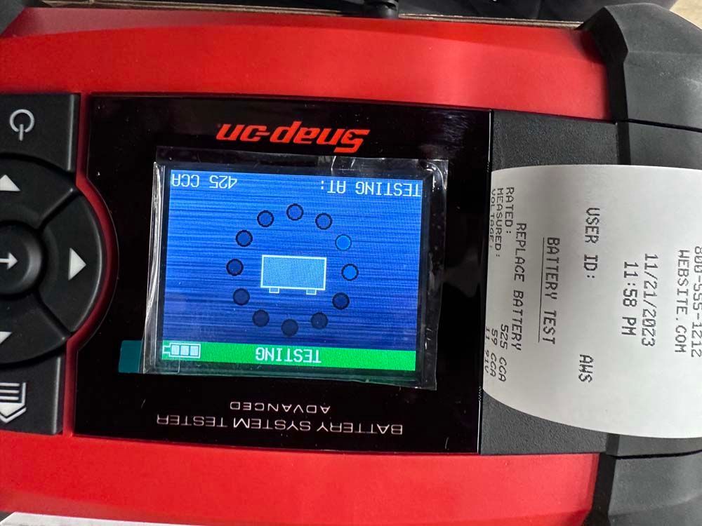 A snap on battery system tester with a receipt attached to it
