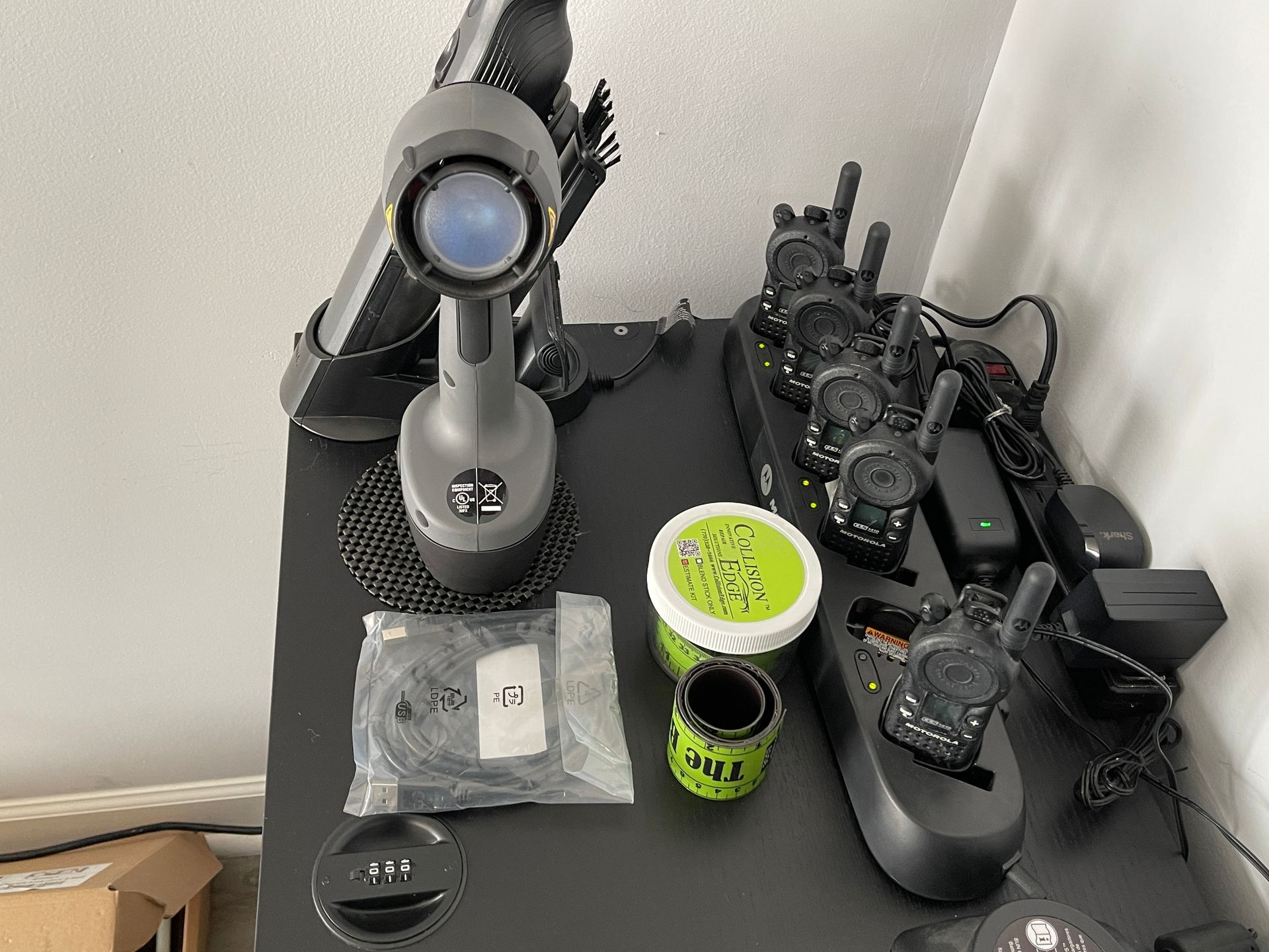 A table with a bunch of walkie talkies on it