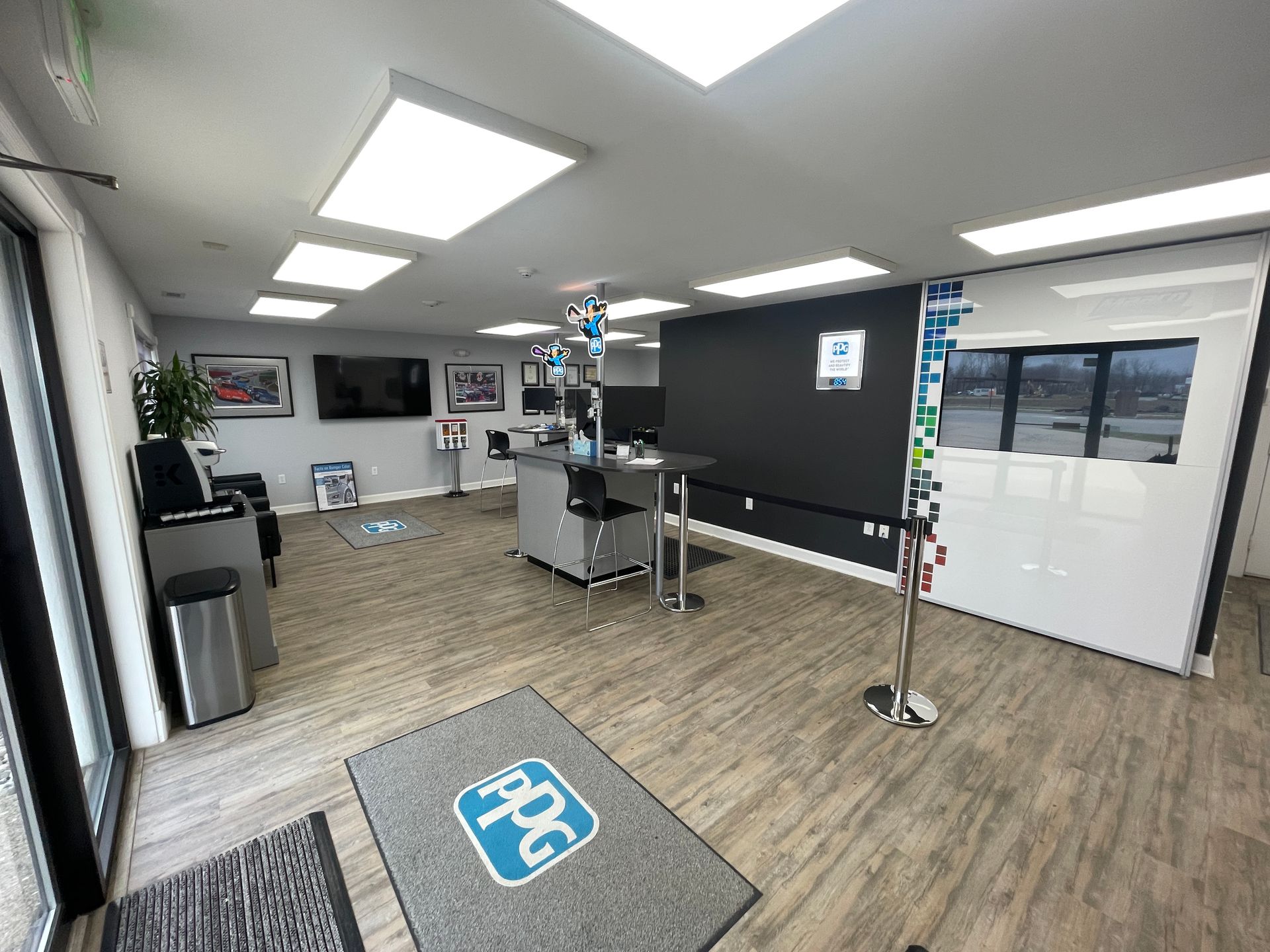 A large room with a rug on the floor and a tv on the wall.