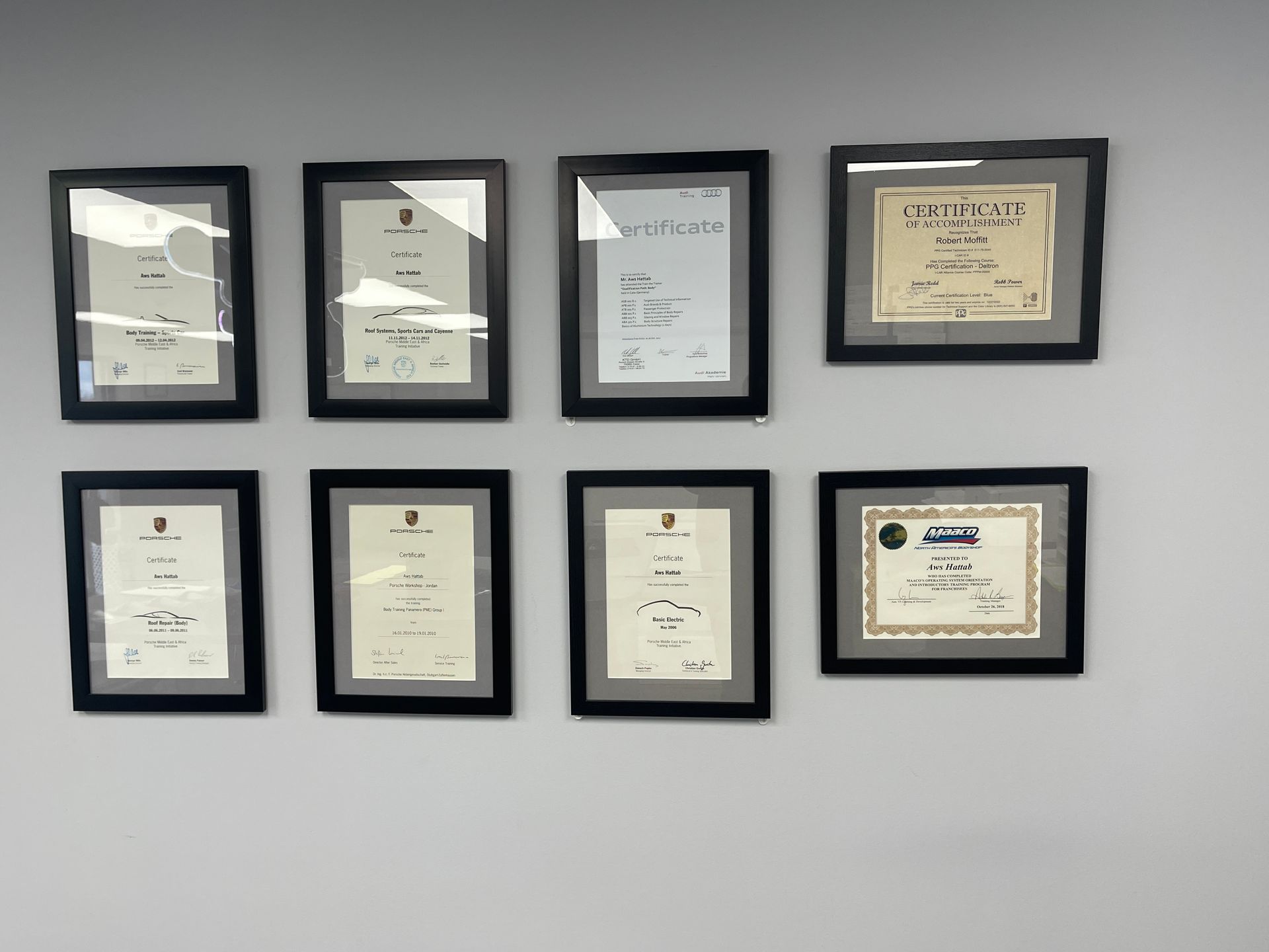 Several framed certificates are hanging on a wall
