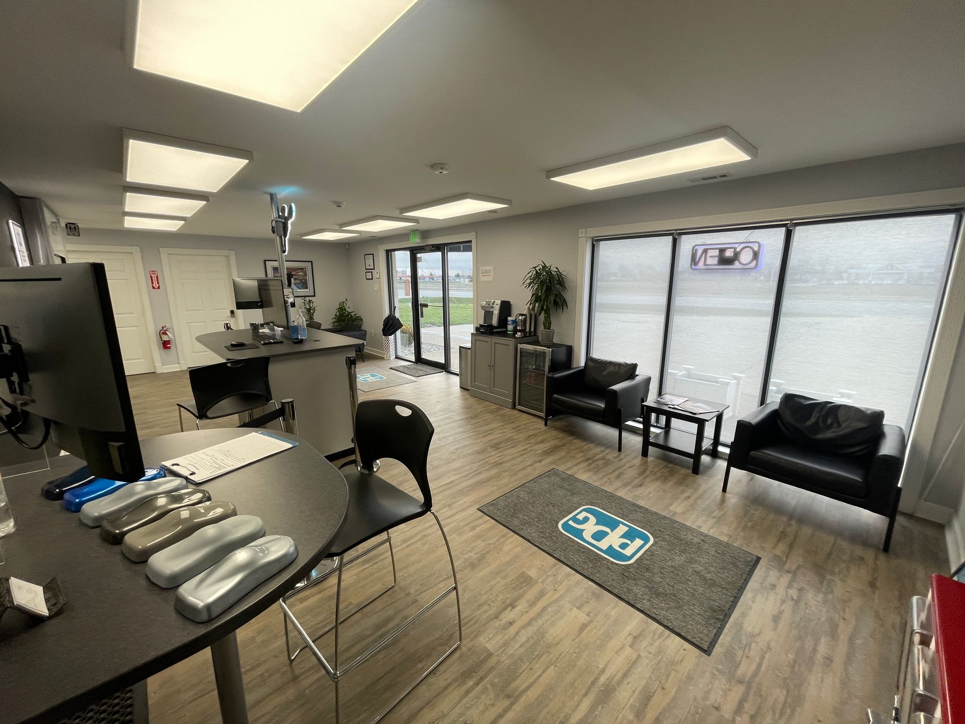 A large room with a lot of windows and a desk with a computer on it.