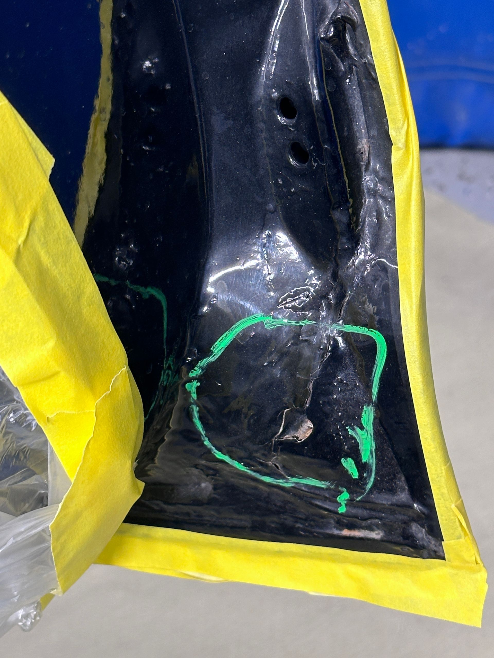 A piece of black plastic with yellow tape around it