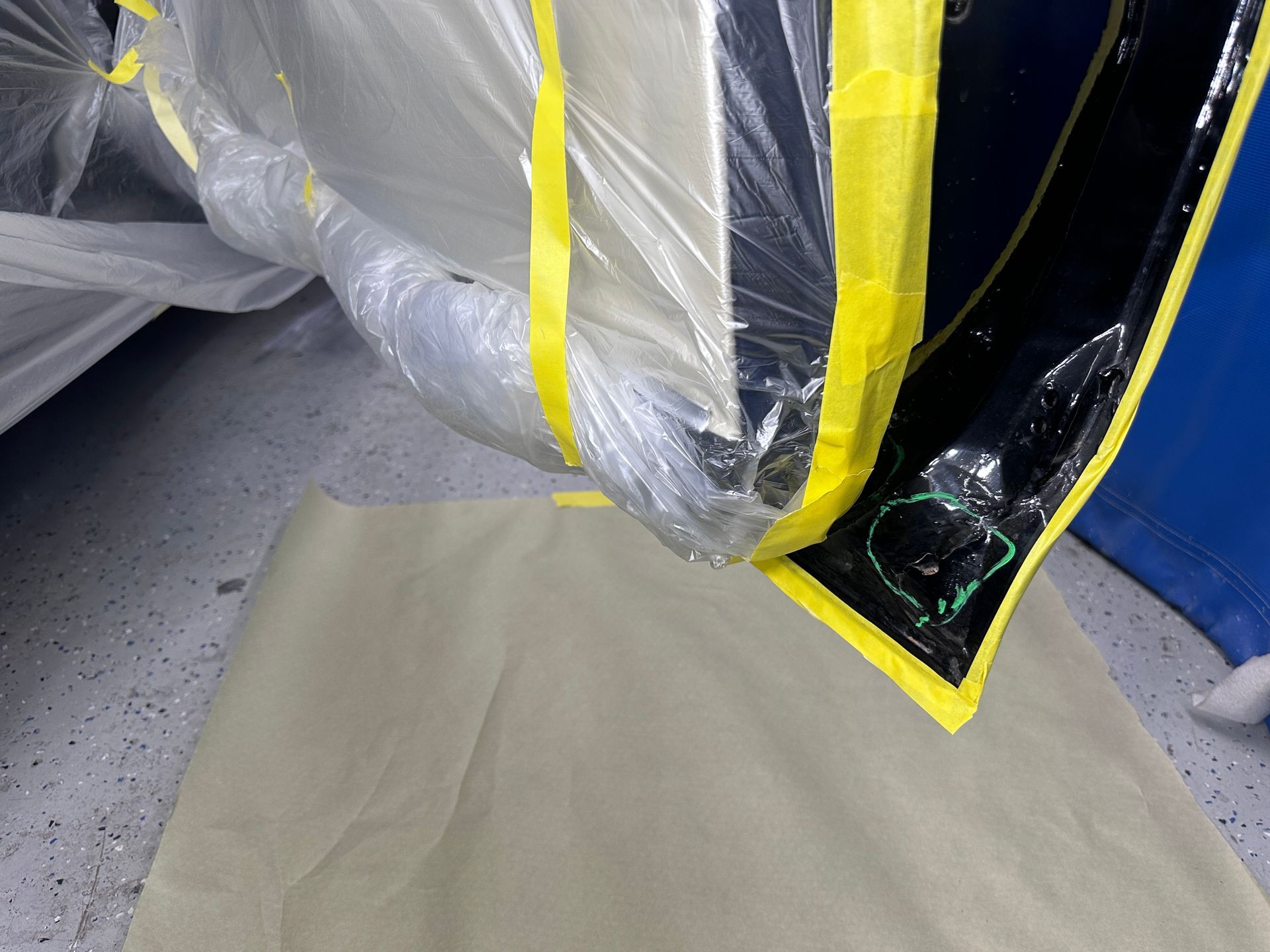 A piece of plastic is taped to a piece of paper