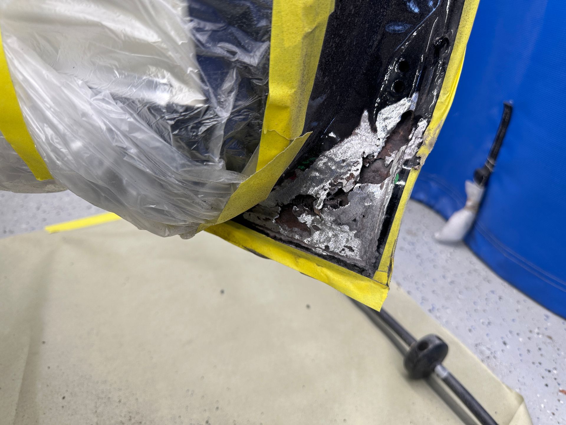 A piece of plastic is taped to a piece of cloth