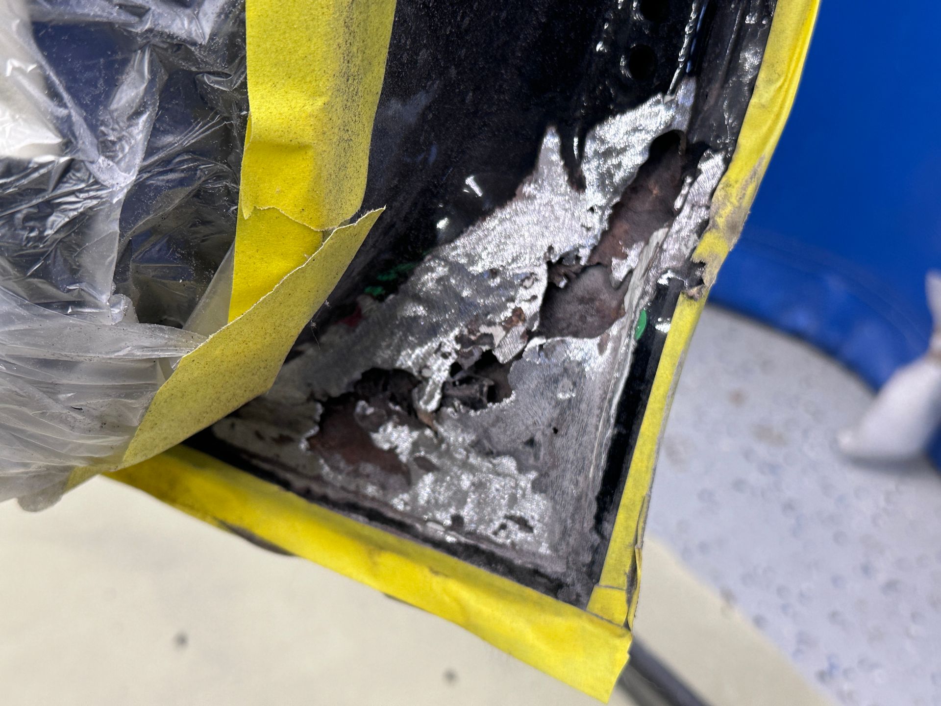 A close up of a piece of metal with yellow tape on it