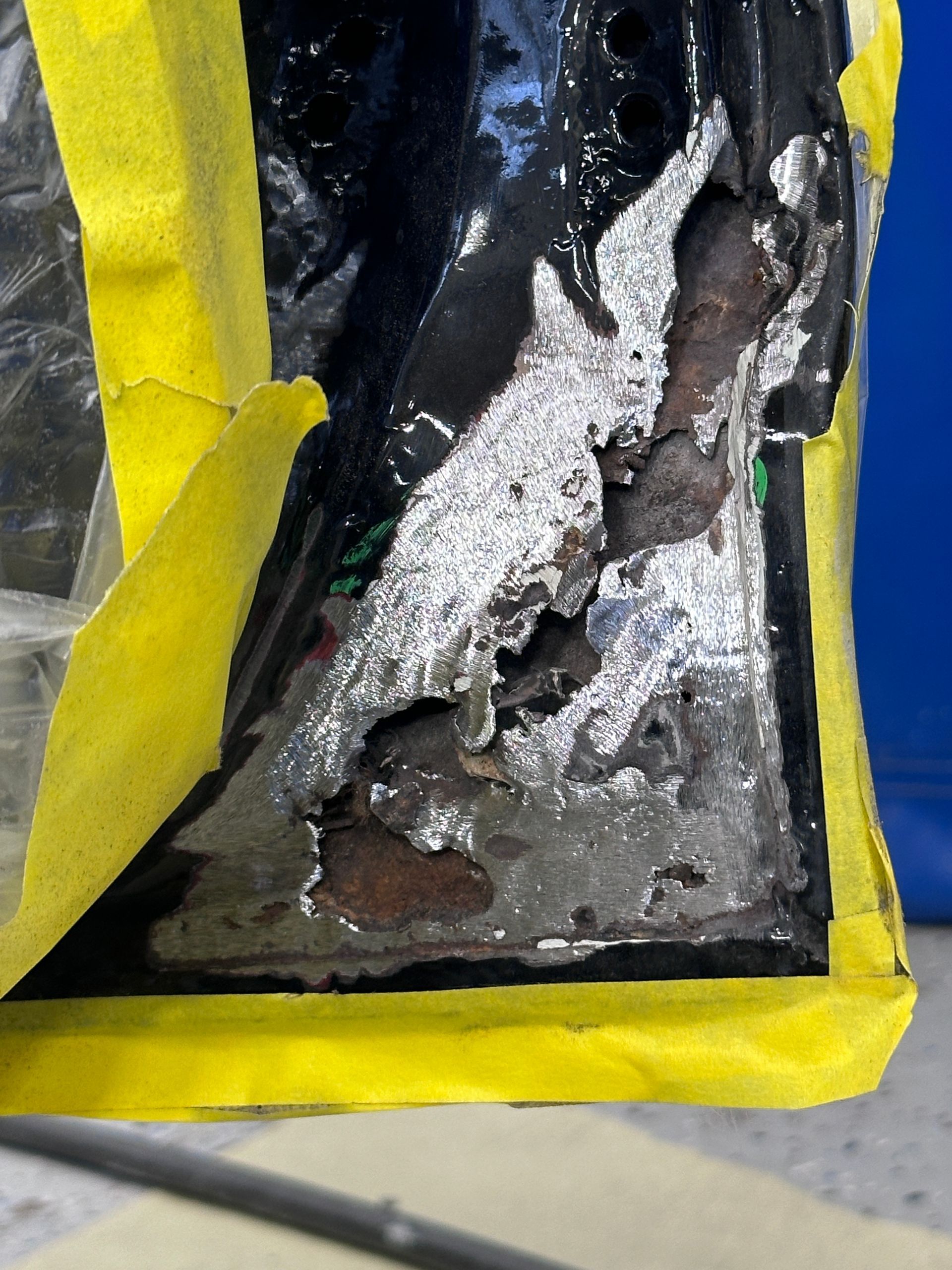 A piece of metal is covered in yellow tape