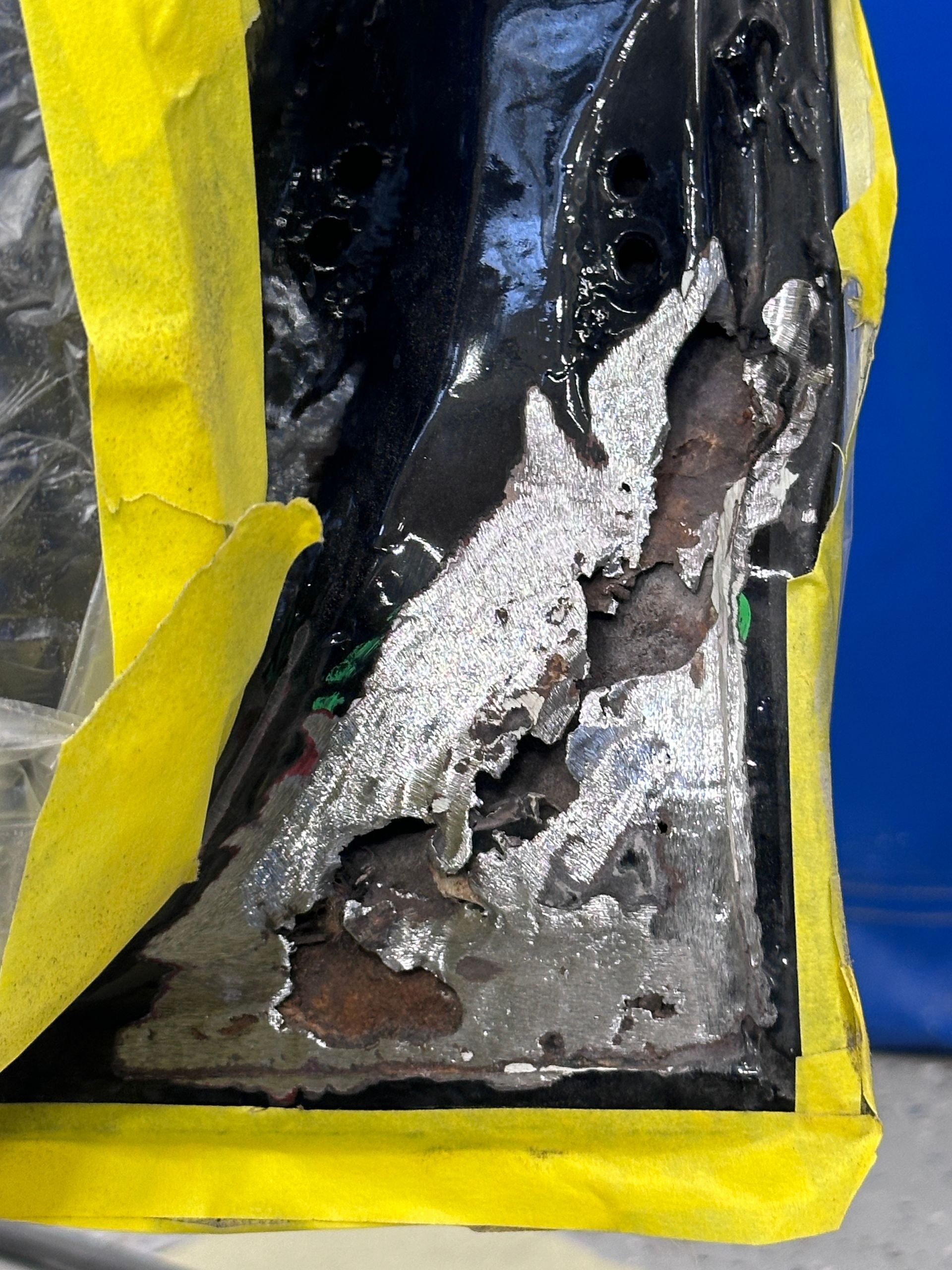 A close up of a piece of metal covered in yellow tape.