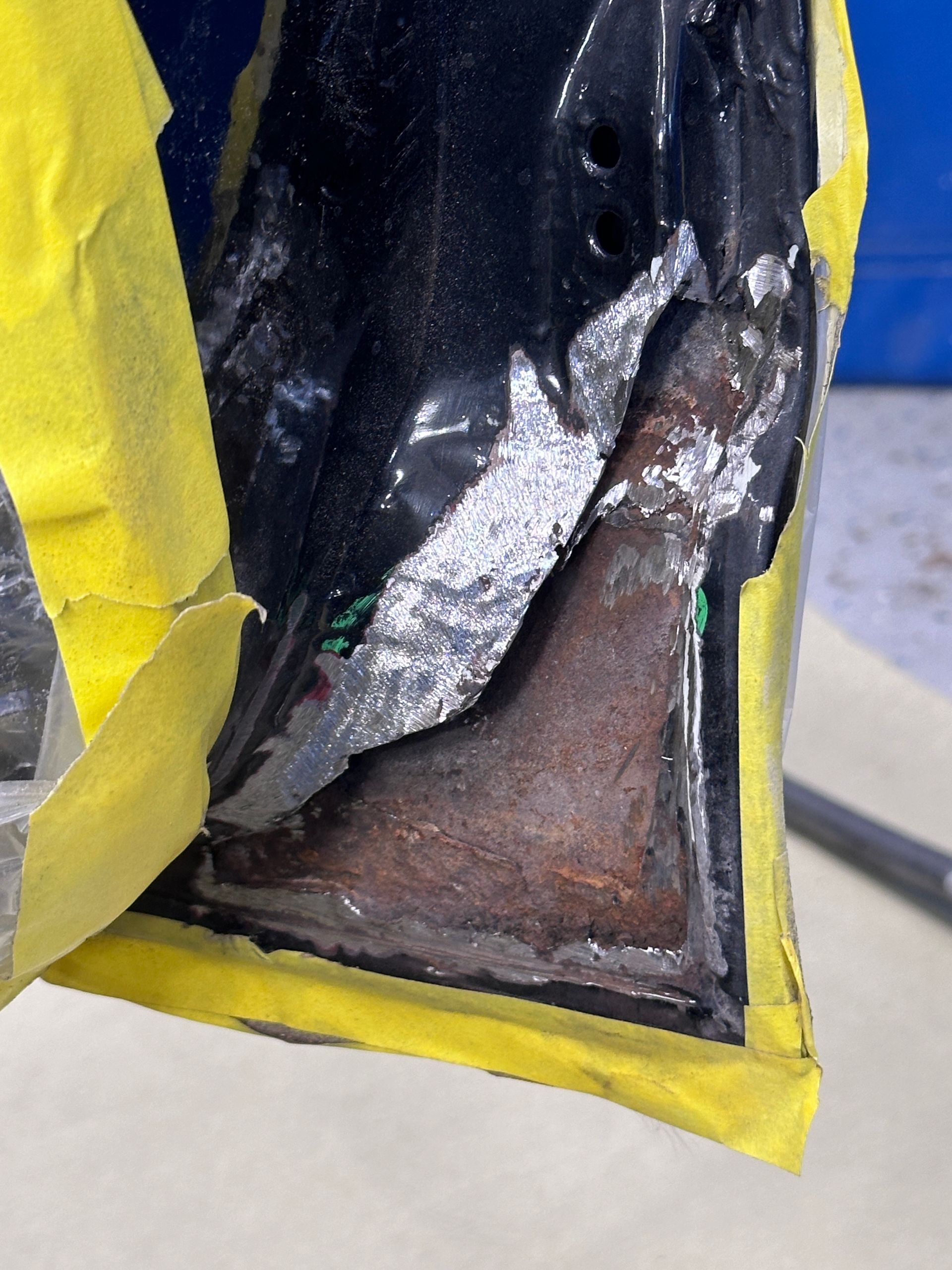 A piece of metal is covered in yellow tape