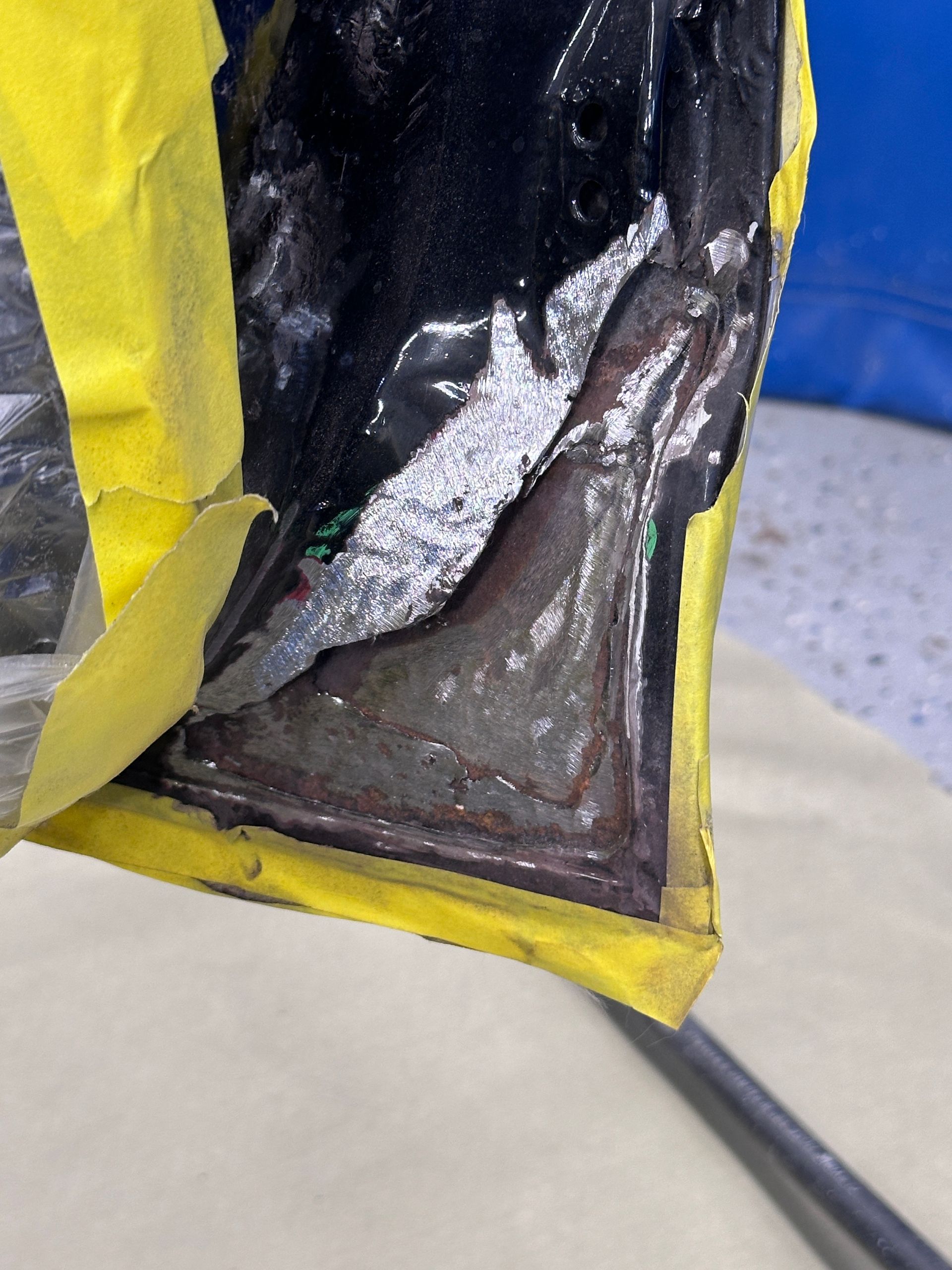 A piece of tape is covering a piece of metal