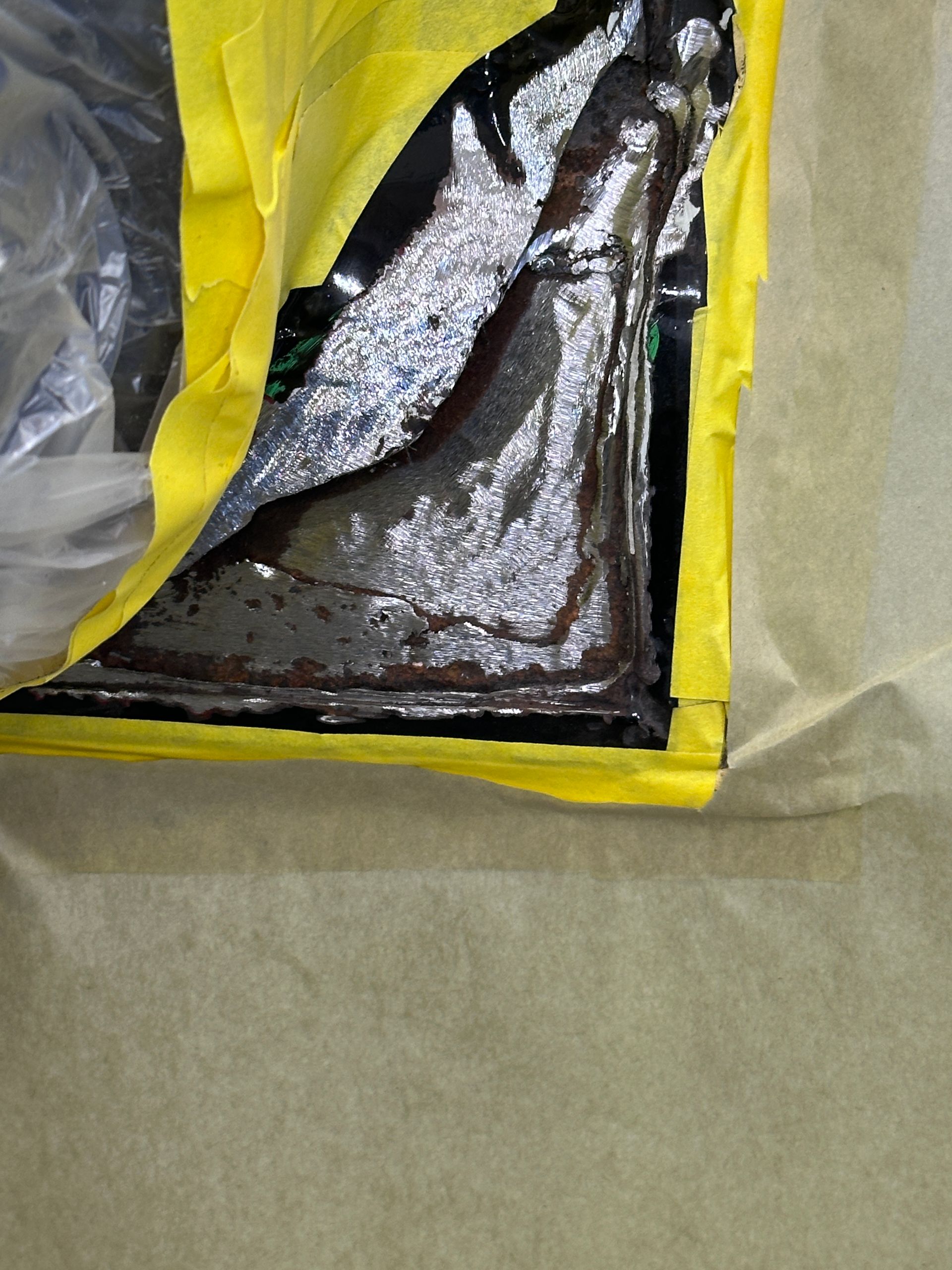 A piece of aluminum foil is taped to a piece of paper