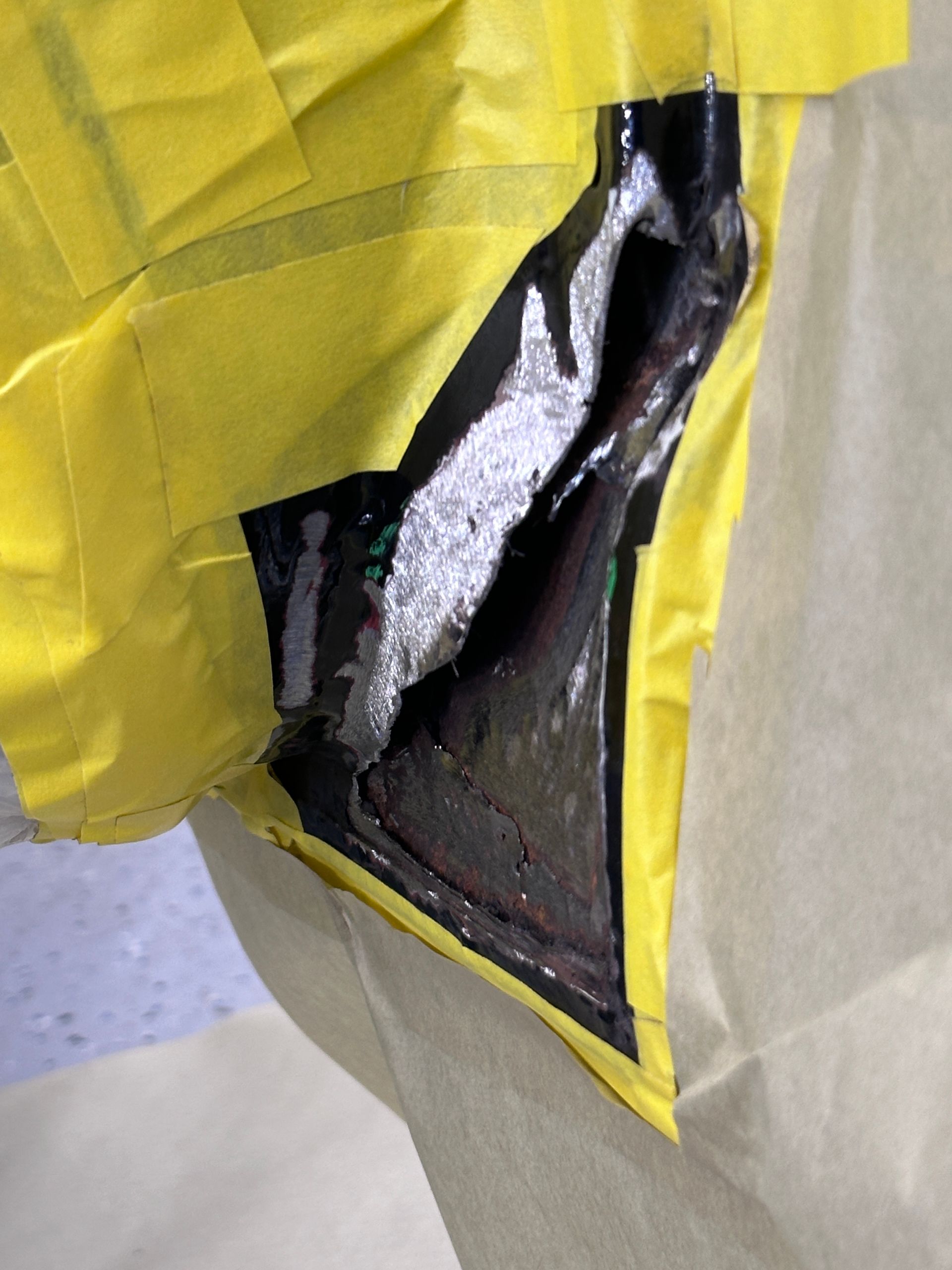 A person wearing a yellow jacket with a hole in it