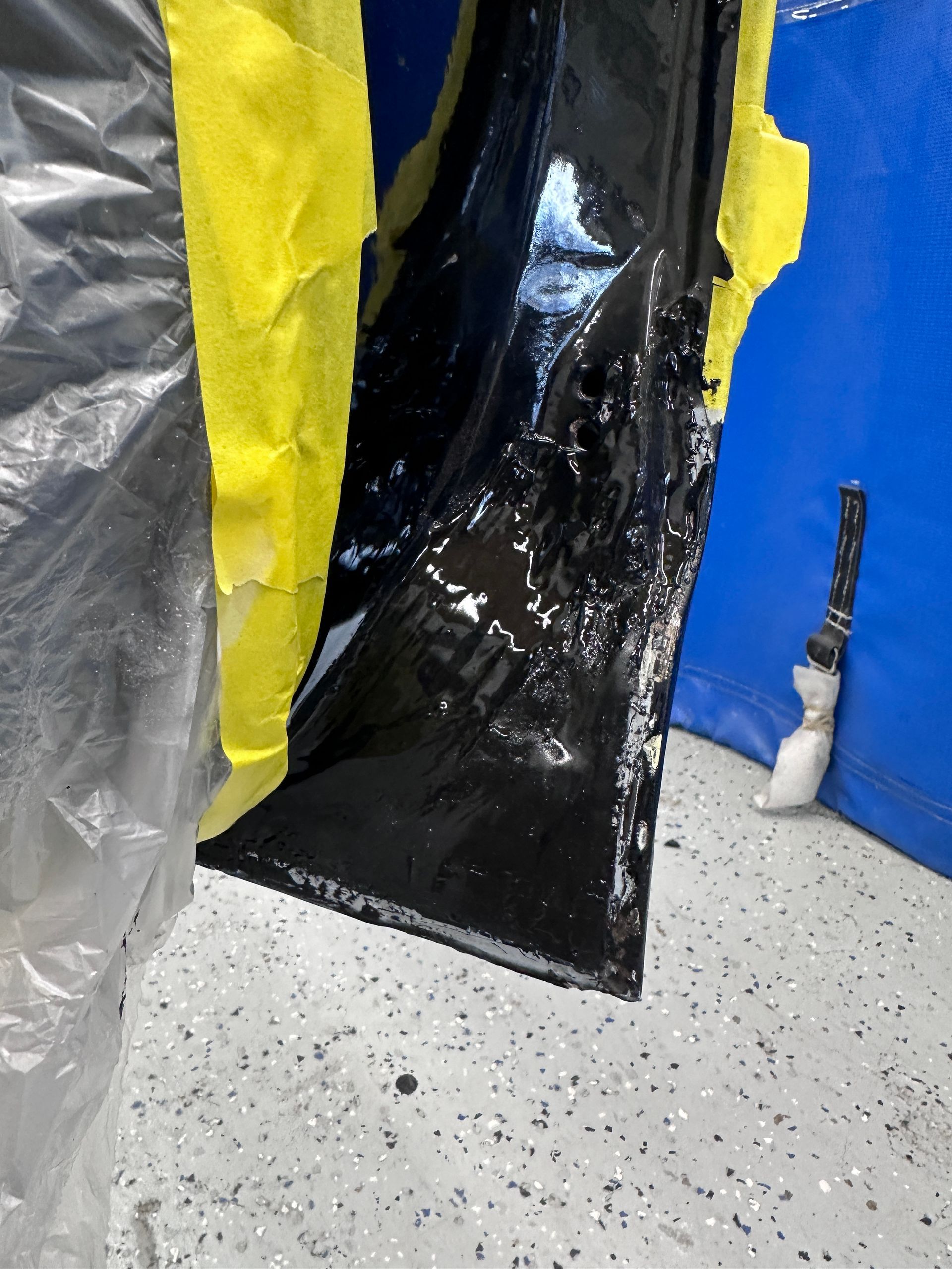 A piece of black plastic with yellow tape on it