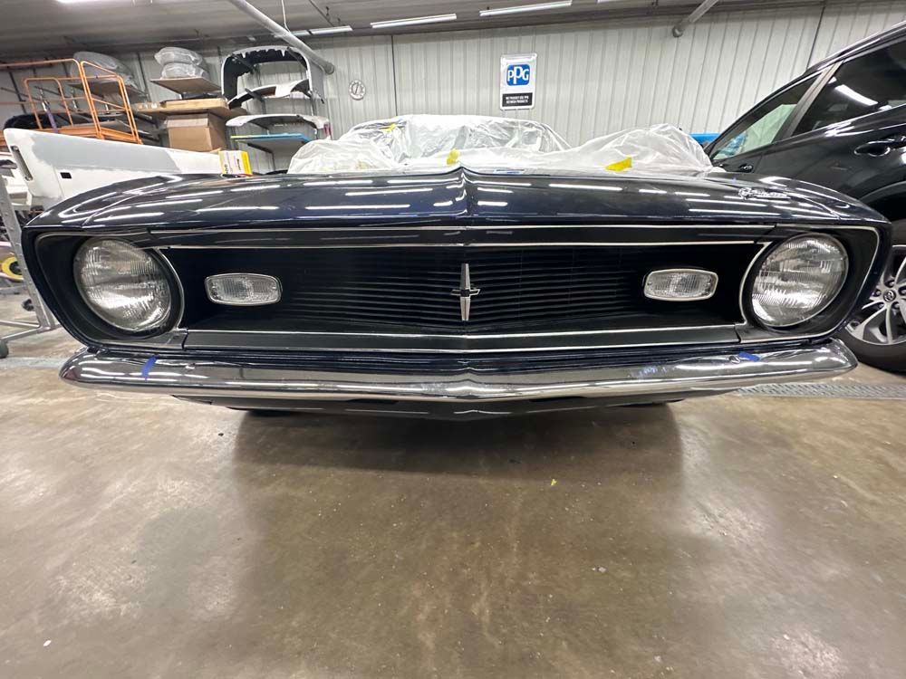 A black car is parked in a garage.