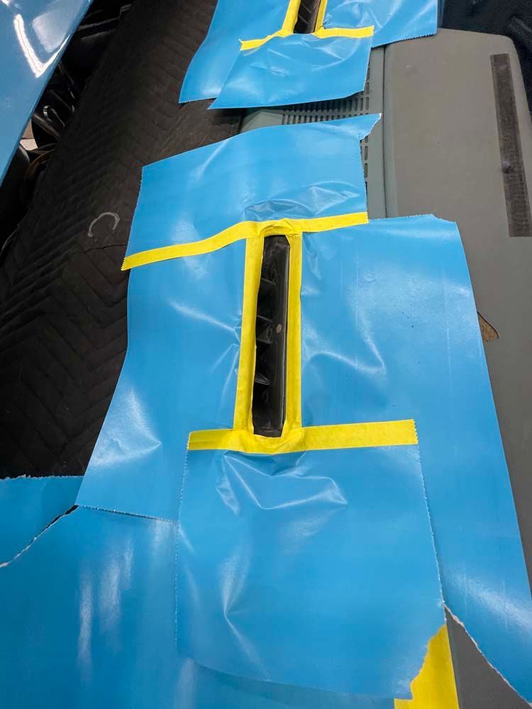 A piece of blue plastic with yellow tape on it