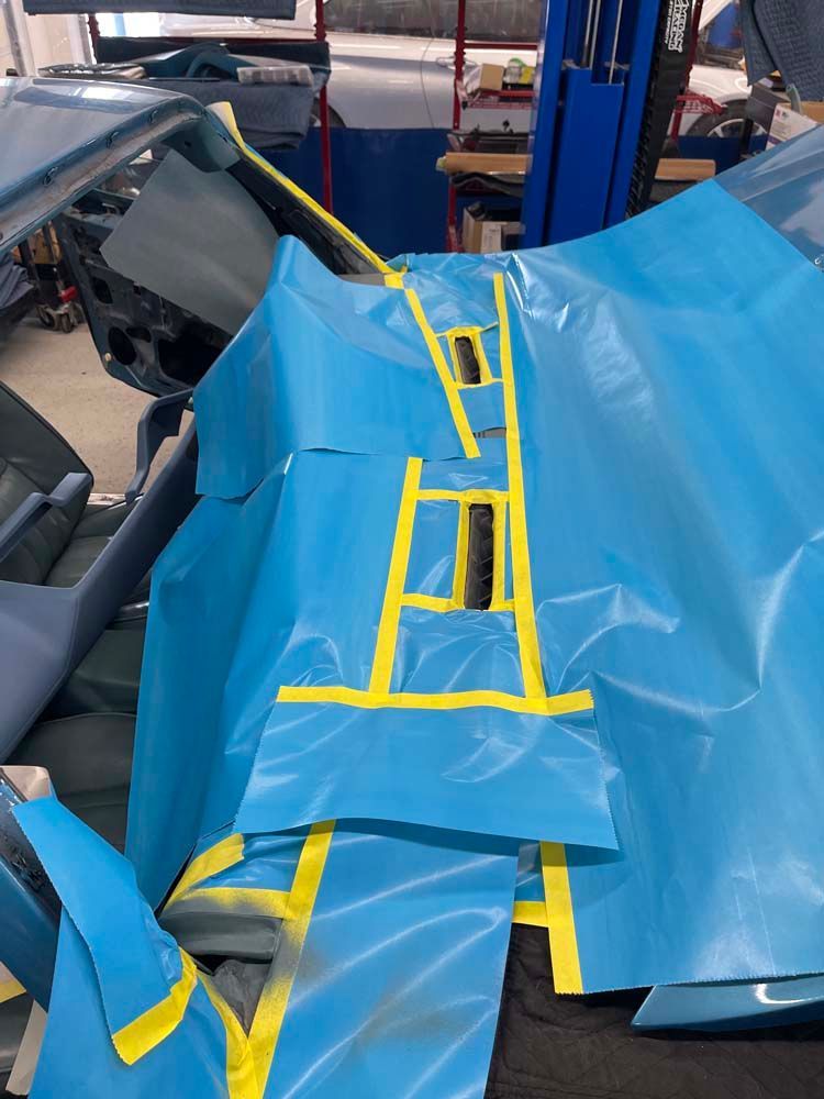 A blue tarp with yellow tape on it