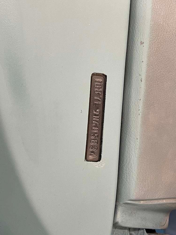 A close up of a license plate on a white car.