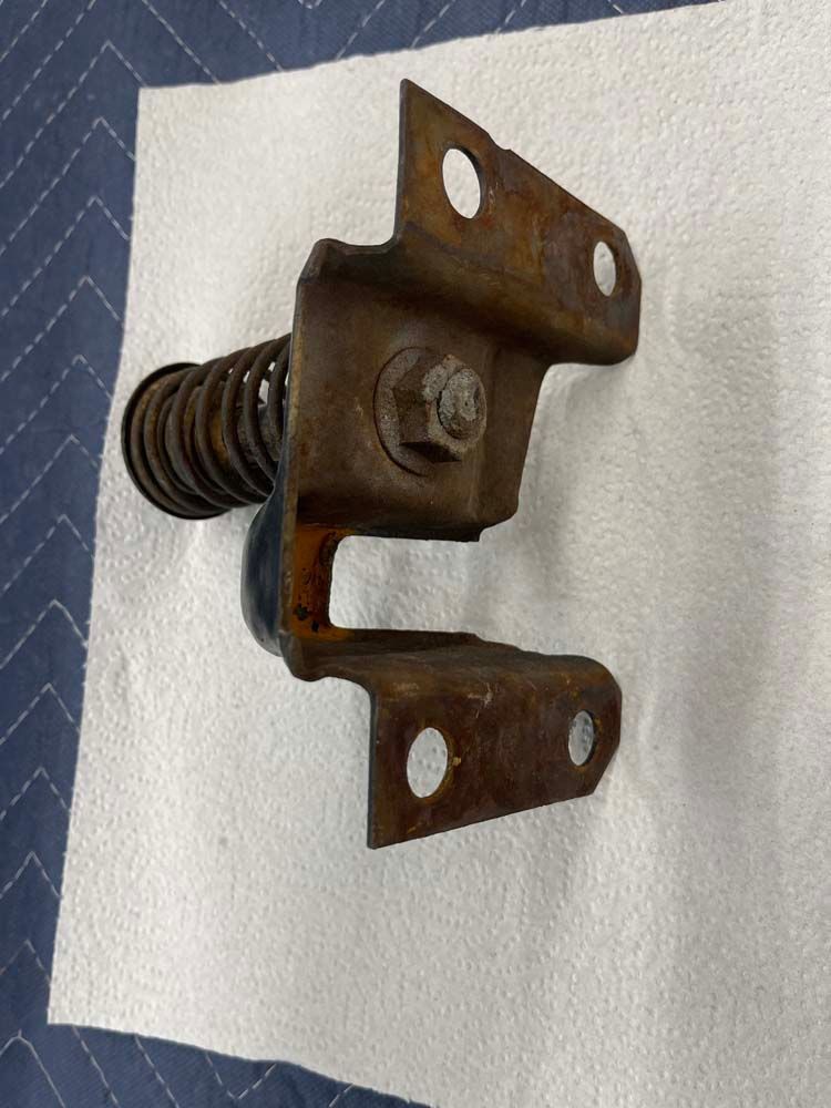 A piece of rusty metal is sitting on top of a paper towel.