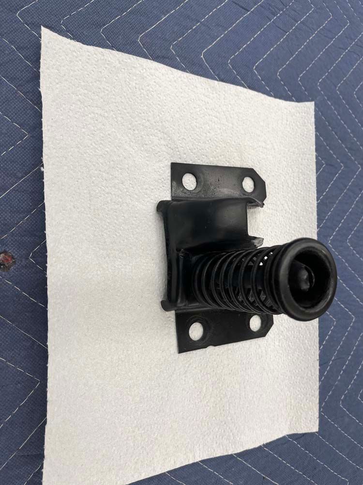 A piece of metal is sitting on top of a piece of paper towel.