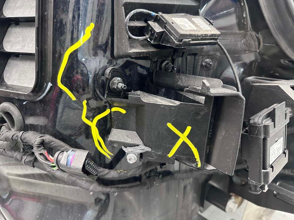 A close up of a car with a yellow x drawn on it.