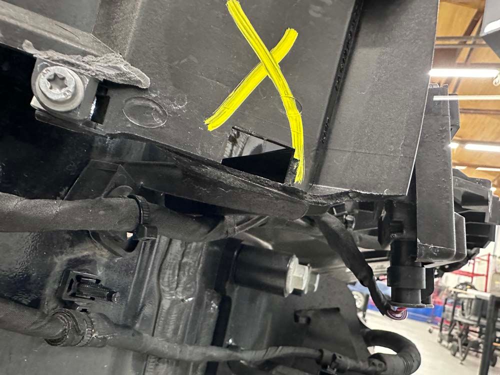 A yellow x is painted on the side of a vehicle