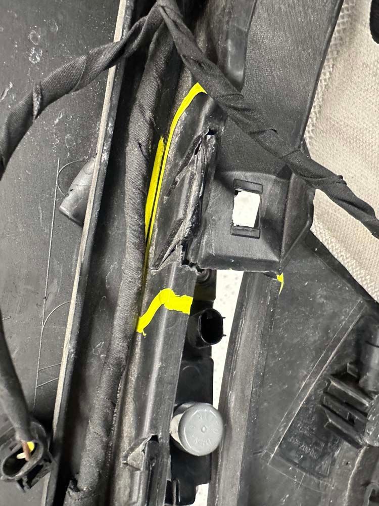 A close up of a black object with a yellow stripe on it.