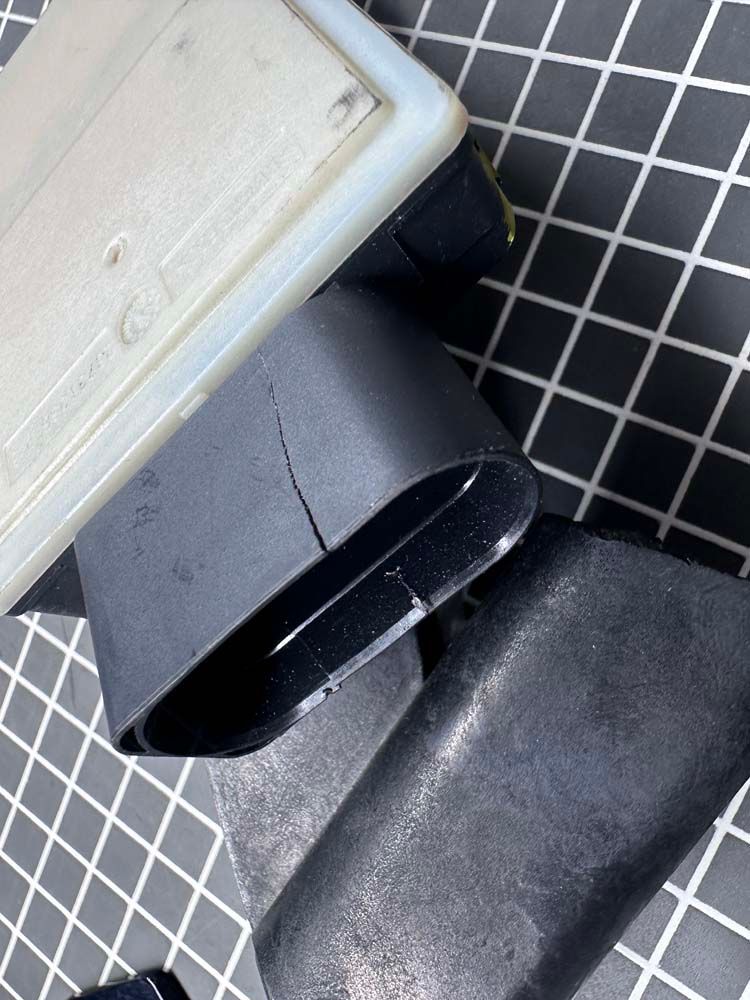 A close up of a black object on a tiled floor.