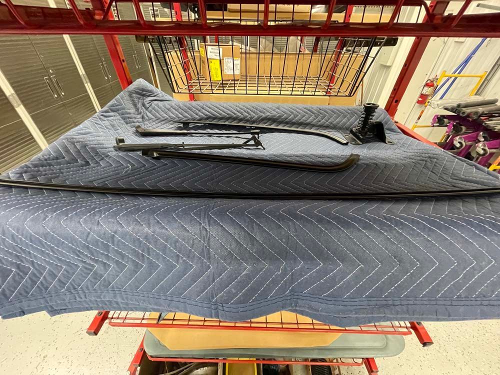 A blue blanket is sitting on top of a red shelf.