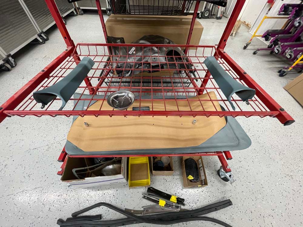 A bunch of parts are stacked on top of each other on a cart