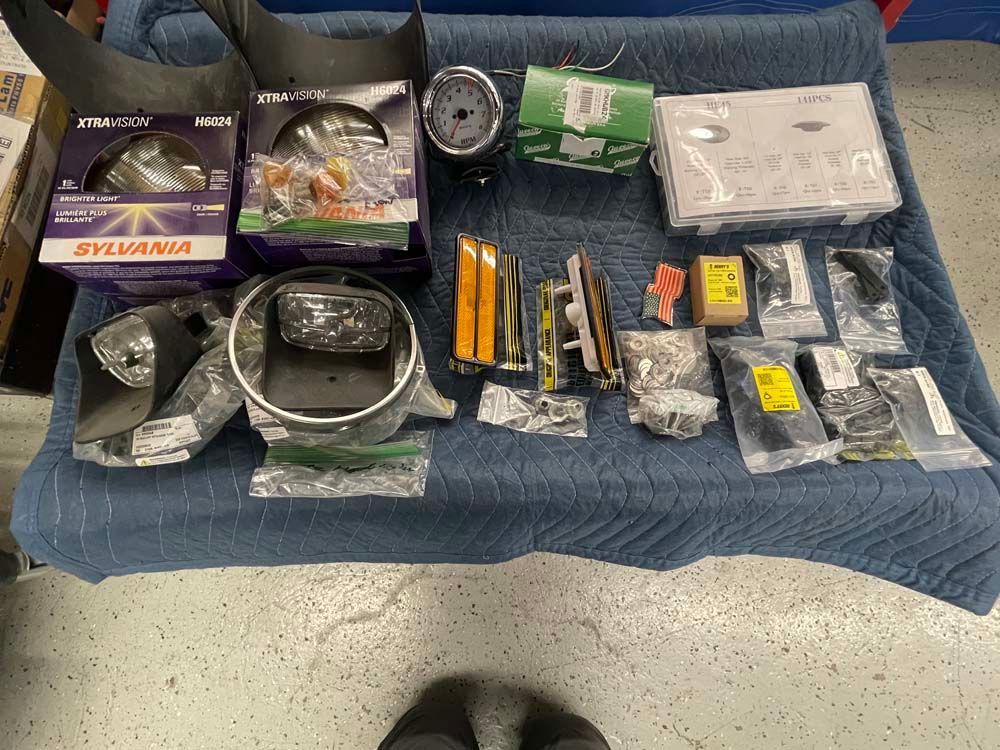 A table with a lot of sylvania parts on it