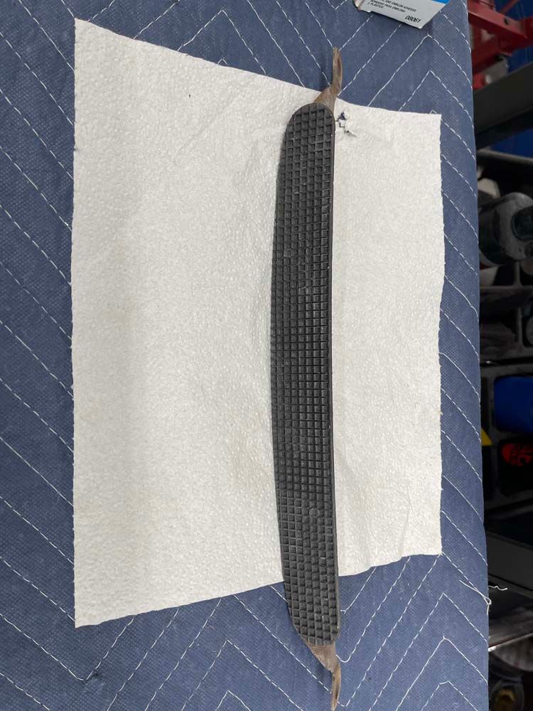 A piece of metal is laying on a piece of paper towel.