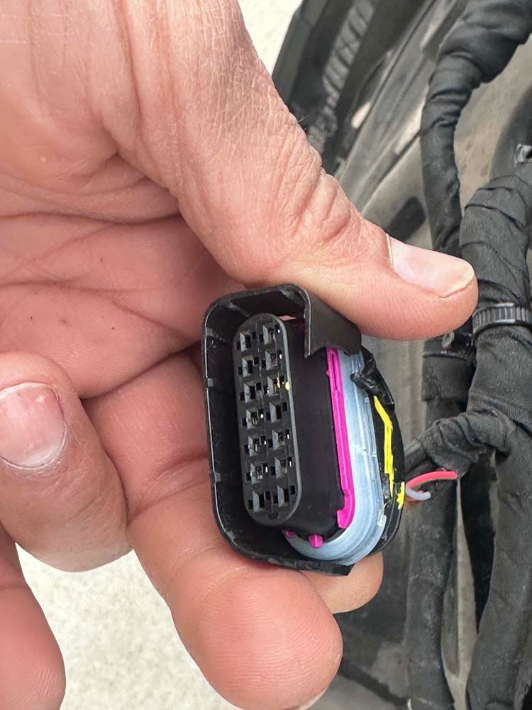 A close up of a person holding a connector in their hand