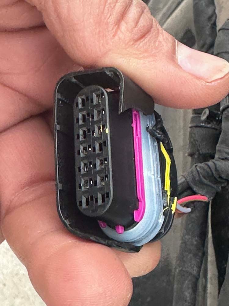 A close up of a person holding a connector in their hand.