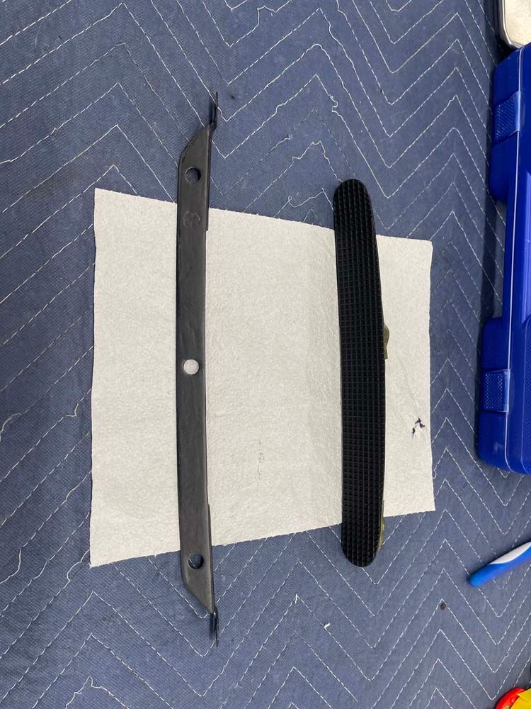 Two pieces of metal are sitting on top of a piece of paper.