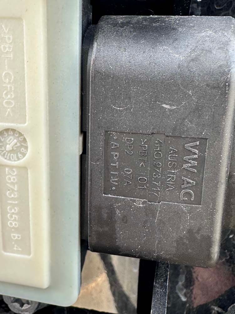 A close up of a fuse box on a car.