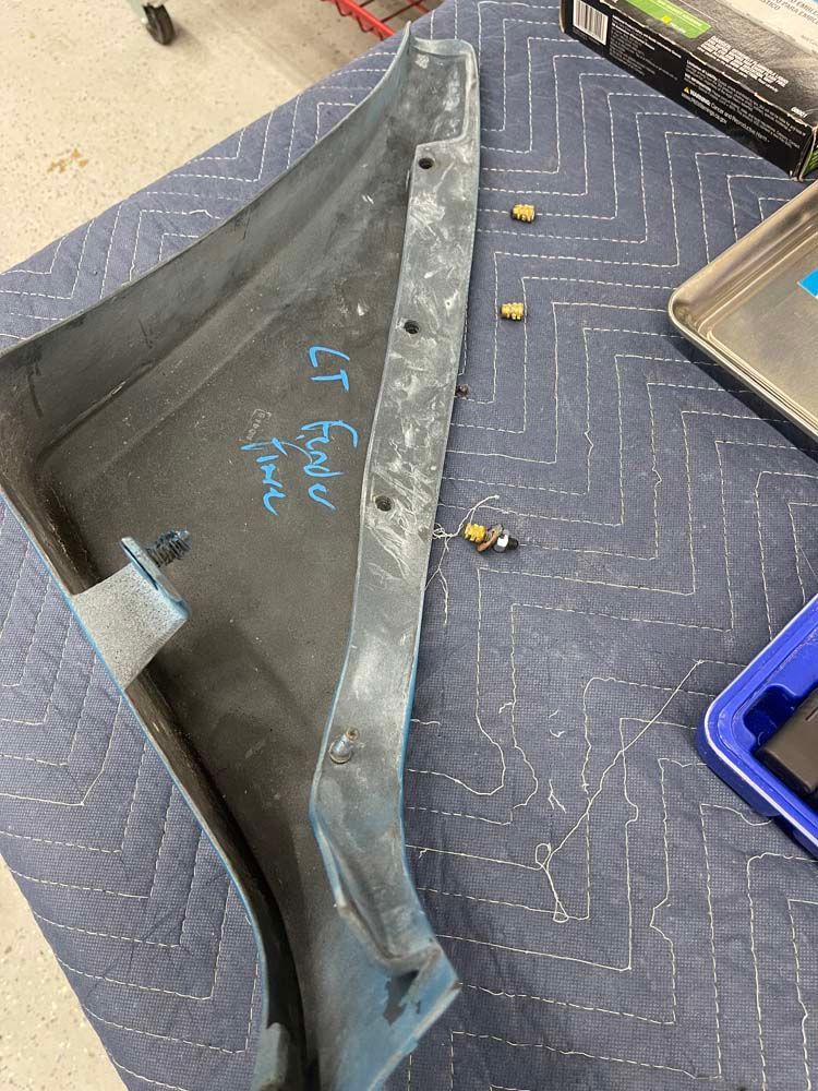 A piece of plastic is sitting on top of a blue blanket on a table.