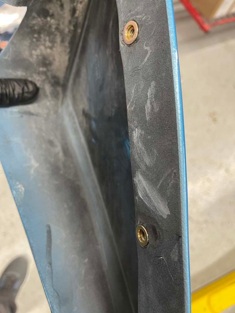 A close up of a piece of plastic with screws on it.