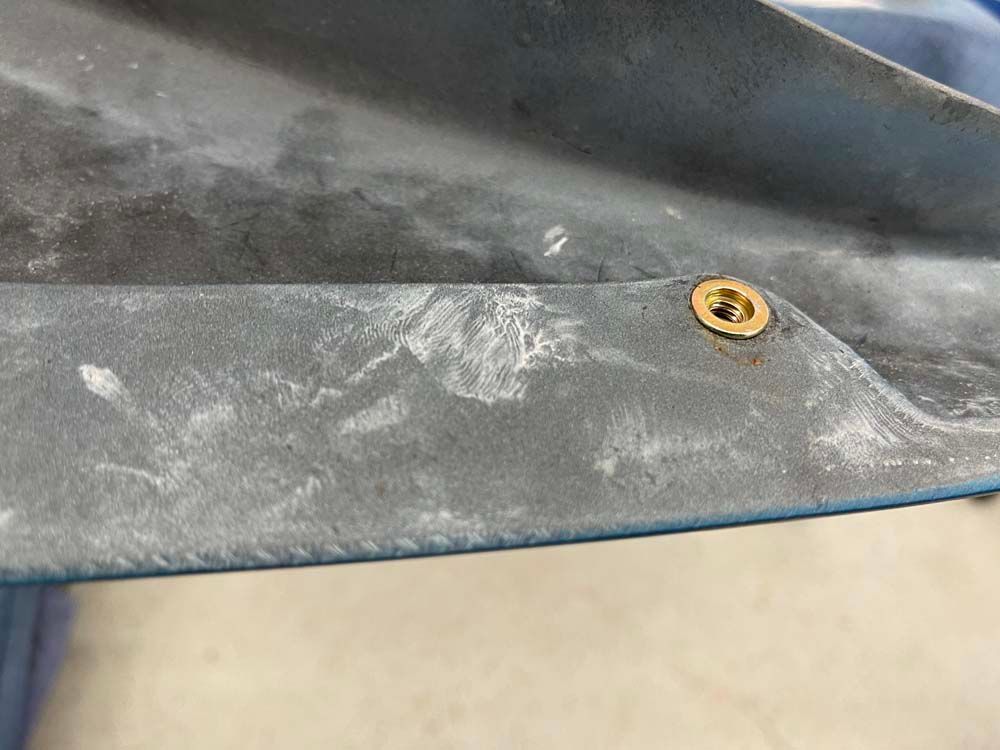 A close up of a piece of metal with a screw in it.