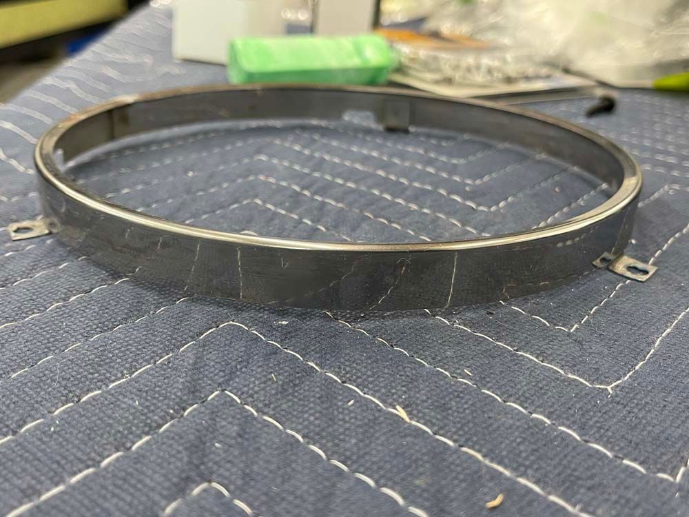 A metal ring is sitting on top of a blue blanket.