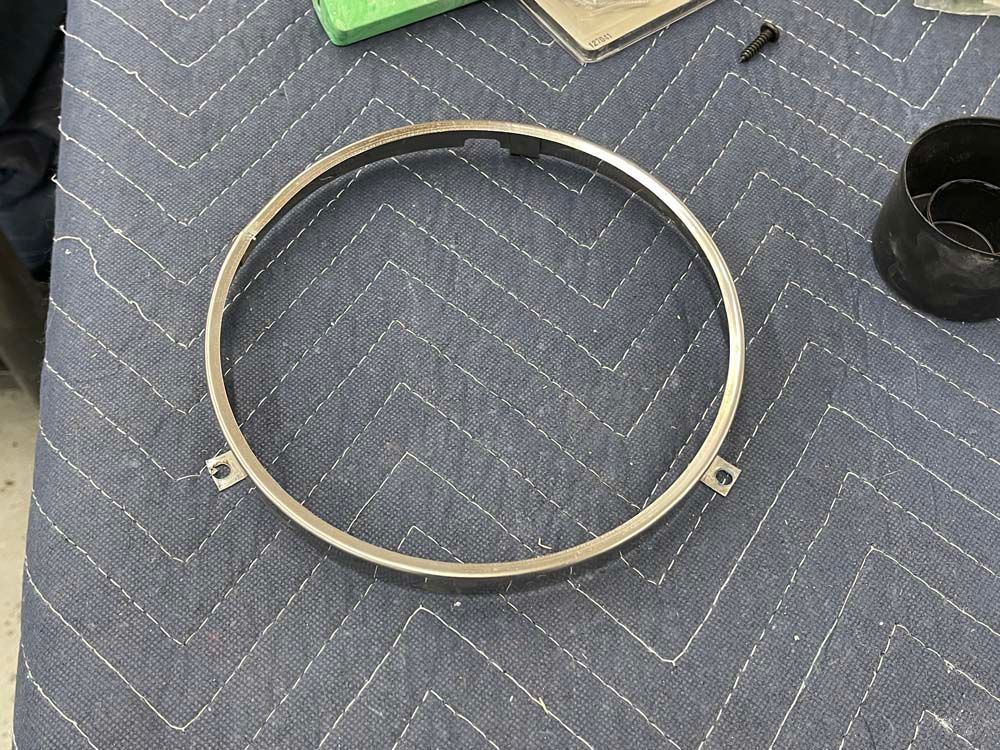 A metal ring is sitting on top of a blue table cloth.