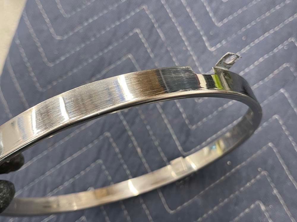 A close up of a metal ring on a blue blanket.