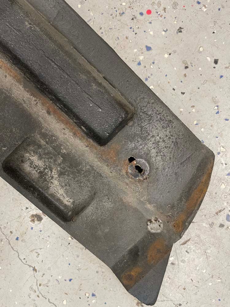 A close up of a piece of metal with a hole in it.