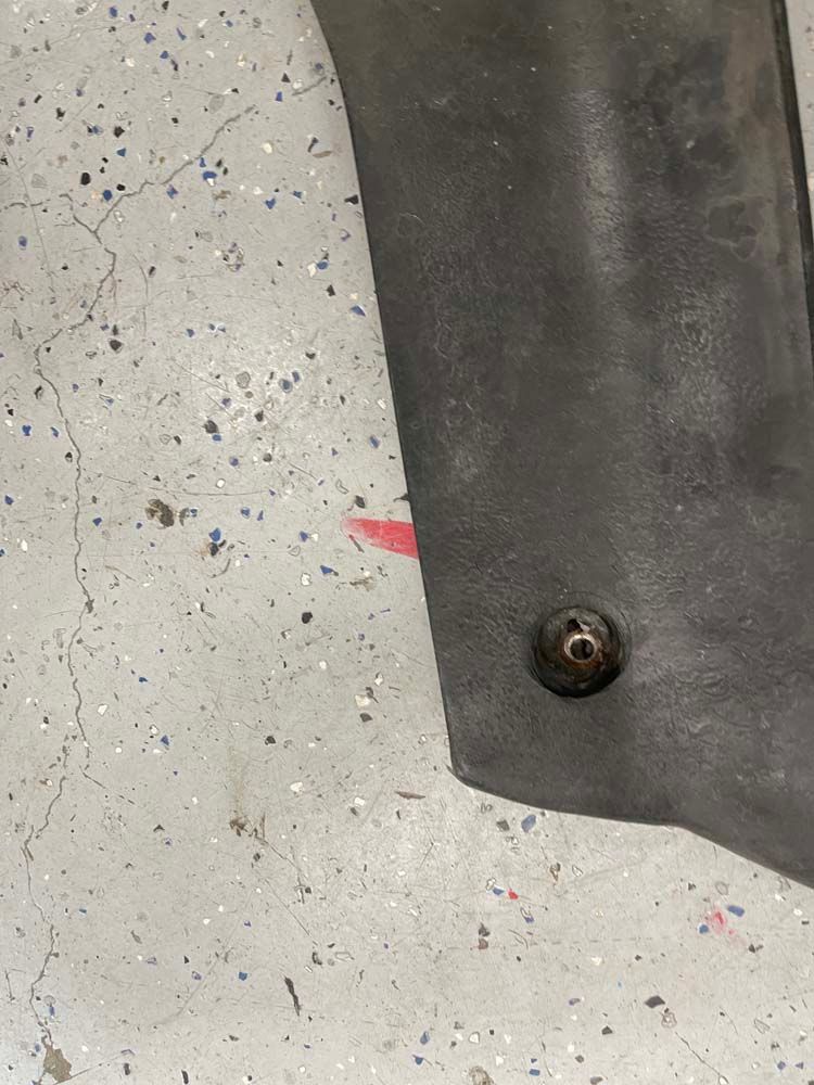 A close up of a piece of metal on a concrete floor.