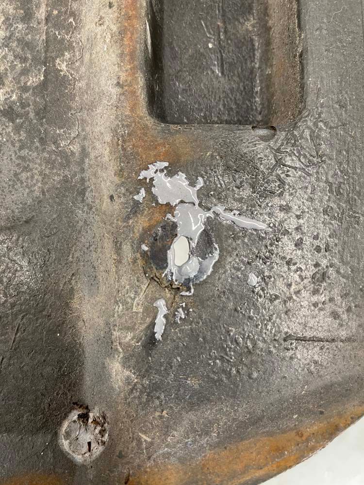 A close up of a piece of metal with a hole in it.