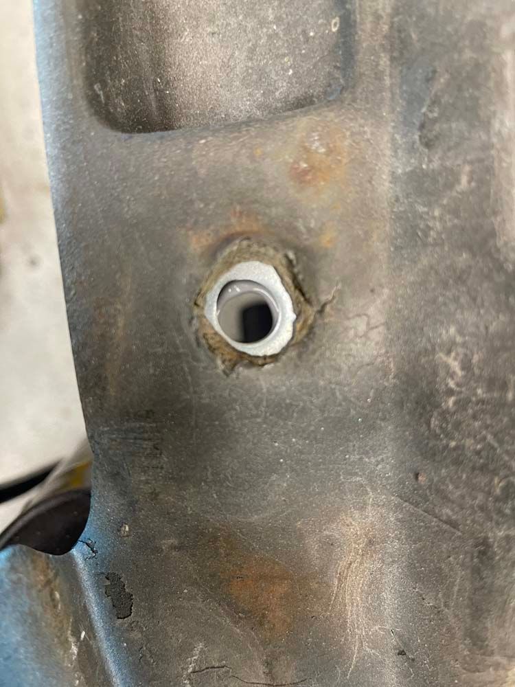 A close up of a metal object with a hole in it.