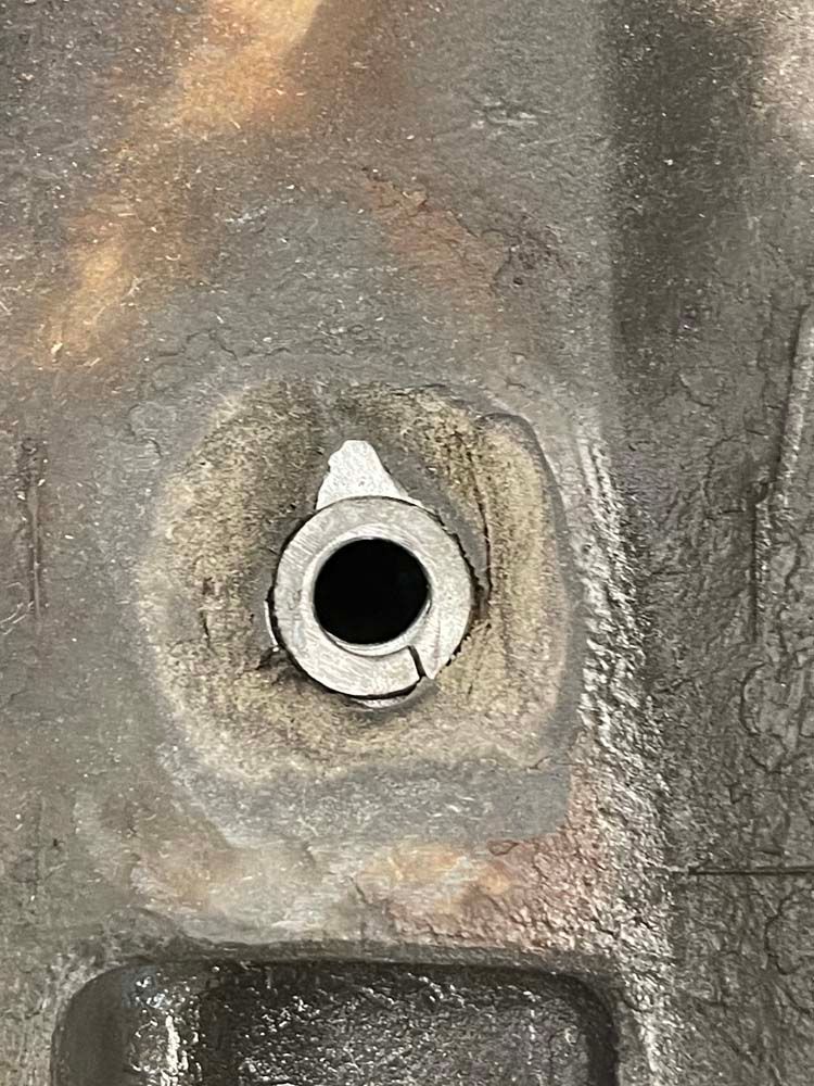 A close up of a metal object with a hole in it.