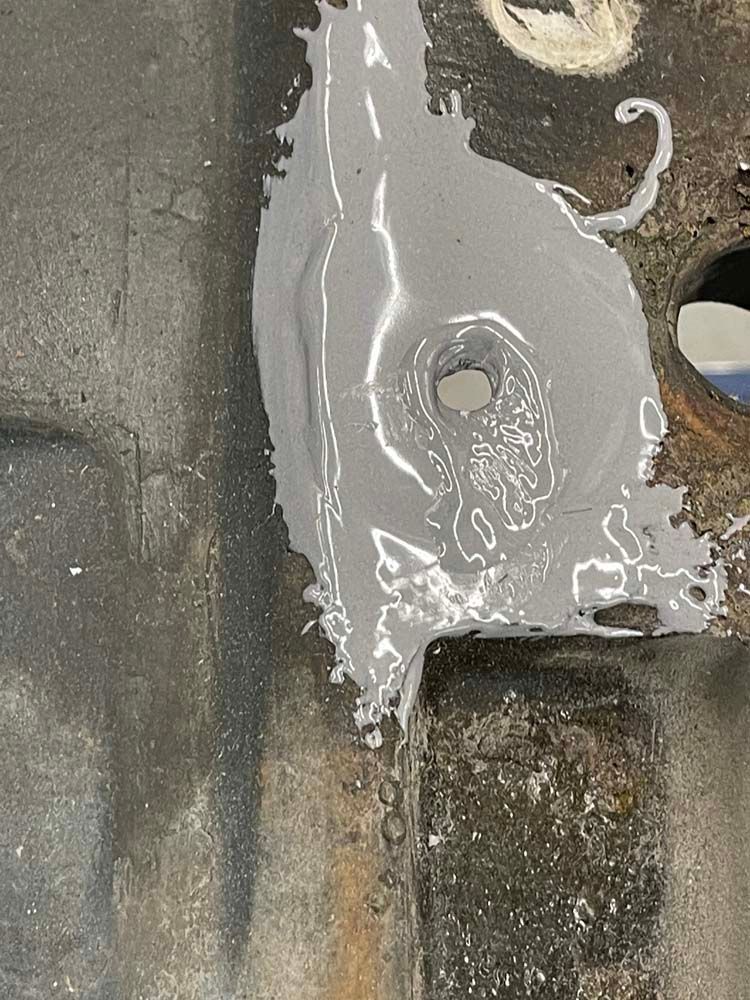 A close up of a piece of metal with a hole in it.